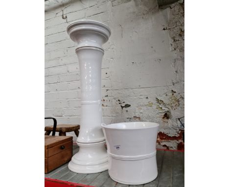 A white ceramic jardiniere. 