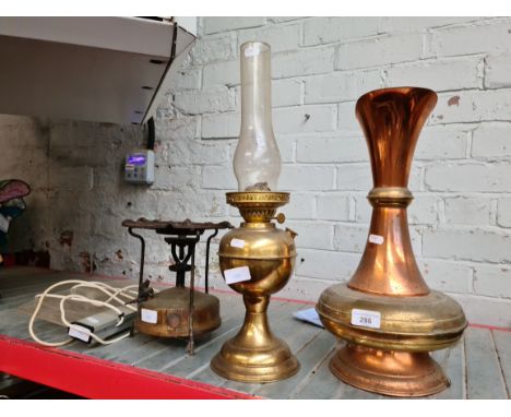 A large copper and brass pitcher, a brass paraffin lamp with funnel - no shade, a Primus stove and a vintage illuminated sign