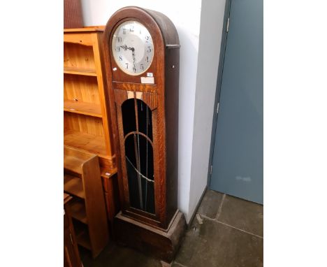 A 1930s Enfield Art Deco oak longcase clock. 