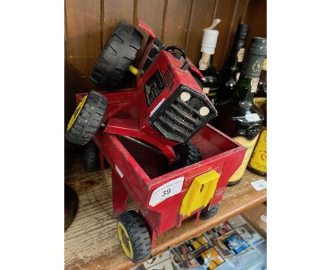 A vintage Tonka tractor and wagon. 