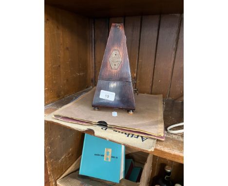 A vintage French metronome and some old gramophone records. 