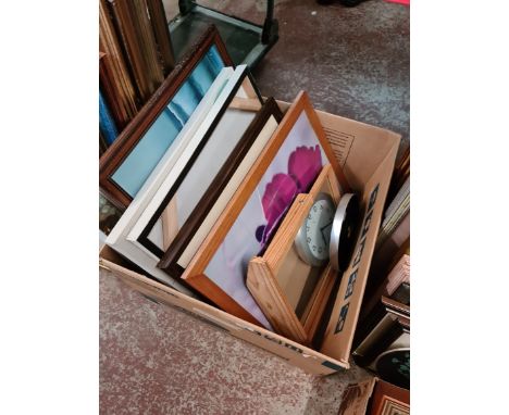 A box of prints, a mirror and a clock. 