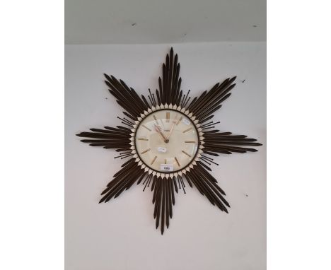 A mid 20th century metal framed sunburst wall clock by Junghans, diameter 60cm. 