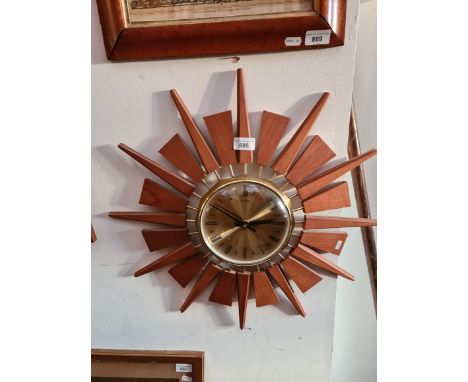 A mid 20th century brass and teak sunburst wall clock by Anstey &amp; Wilson, diameter 53.5cm. 