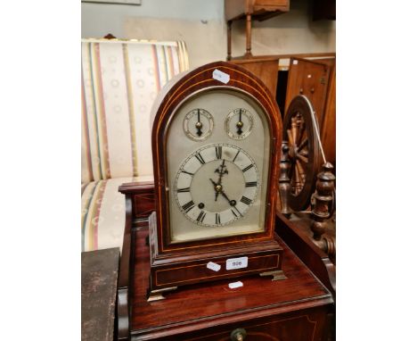 An Edwardian inlaid mahogany chiming mantle clock with pendulum and key.Condition:- General wear with some marks & scratches 