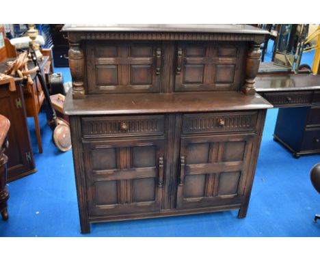 A vintage Priory or dark Ercol court cupboard