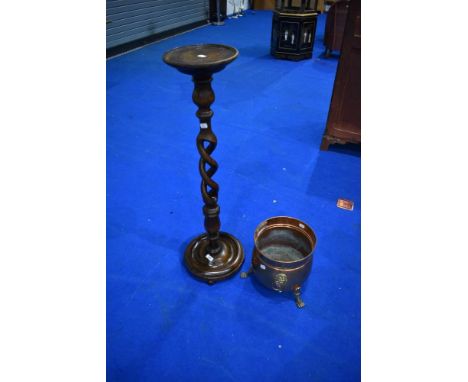 An early to mid 20th Century torchere having open twist column and a copper planter
