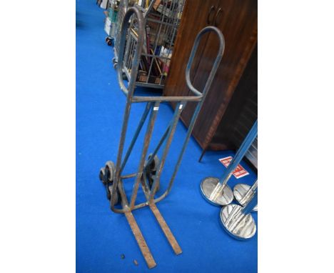 A vintage piano or similar moving trolley, with revolving stair wheels