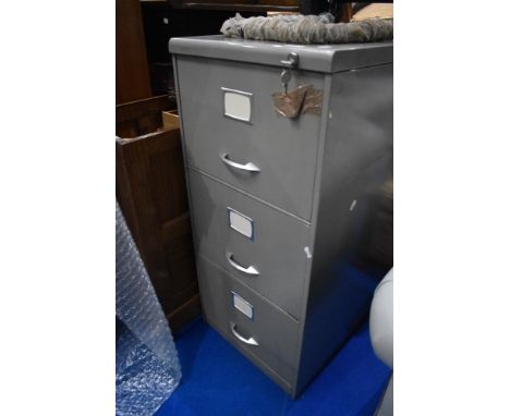 A vintage three drawer filing cabinet