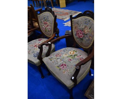 A pair of late Victorian salon armchairs having tapestry upholstery