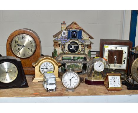 A COLLECTION OF ASSORTED CLOCKS AND BAROMETERS, including three oak cased mantel clocks, a battery operated Flying Scotsman c