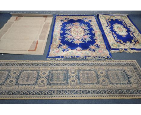 TWO WOOLLEN CHINESE RUG, with a dark blue field, largest rug 178cm x 124cm, a woollen carpet runner, and another rug (4)