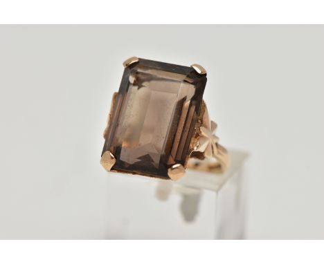 A 9CT GOLD SMOKEY QUARTZ DRESS RING, a four claw set large rectangular cut smokey quartz, openwork gallery, butterfly detail 