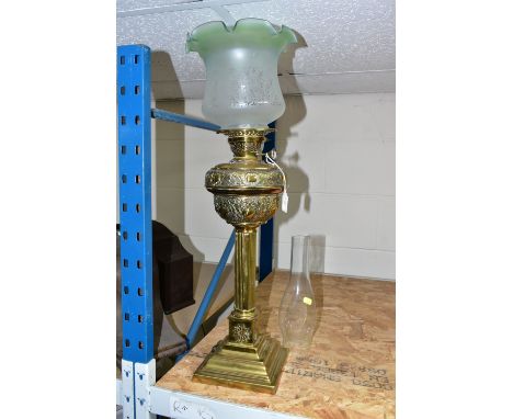 A VICTORIAN, BRASS BASED OIL LAMP, the acid etched clear and opaque, green, fluted shade above a brass, foliate embossed rese