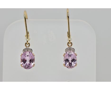 A PAIR OF YELLOW METAL DROP EARRINGS, each earring designed with a double four claw set, oval cut pink spinel, single cut dia