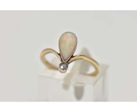 A YELLOW METAL OPAL AND DIAMOND RING, milgrain collet mounted pear shape opal cabochon and a single rose cut diamond, curved 