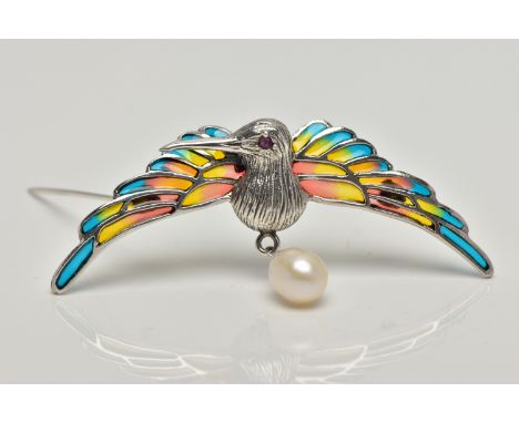 A WHITE METAL PLIQUE A JOUR HUMMINGBIRD BROOCH, the textured hummingbird, with circular cut ruby eye detail, enamelled wings,