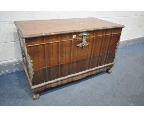 A BRAZILIAN WALNUT SERPENTINE BLANKET CHEST, with brass mounts and handles, and raising internal shelf, on ball and claw feet