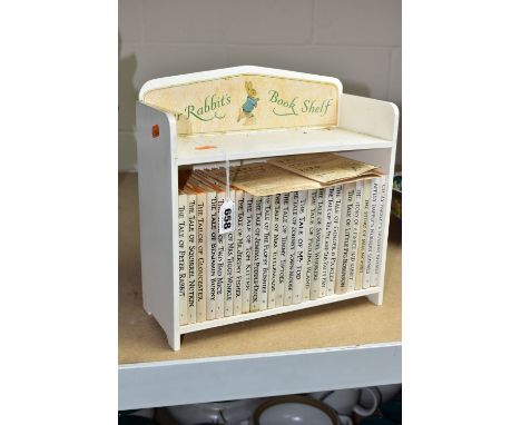 A 1970'S PETER RABBIT'S BOOKSHELF IN WHITE CONTAINING A SET OF TWENTY THREE BEATRIX POTTER BOOKS, together with a list of rel