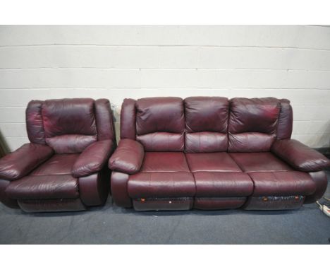 A PLUM COLORED LEATHERETTE THREE SEATER MANUAL RECLINING CHAIR, along with a matching rocking armchair (condition - some surf