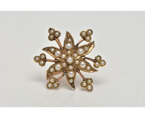A YELLOW METAL BROOCH/PENDANT, in the form of a flower, set with split pearls, fitted to the reverse with a bail and brooch p