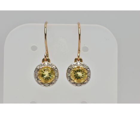 A PAIR OF YELLOW METAL GEM SET EARRINGS, each designed with a circular drop set centrally with a circular cut peridot, within