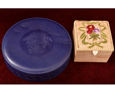 A Gianni Versace circular leather box and a tapestry work box.