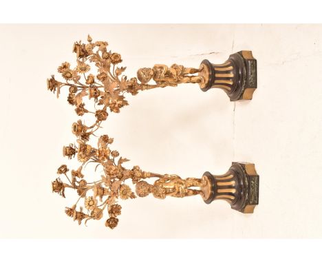 A pair of French gilt ormolu putti five light candelabra standing on shaped marble base with pedestal above, putti figure sta