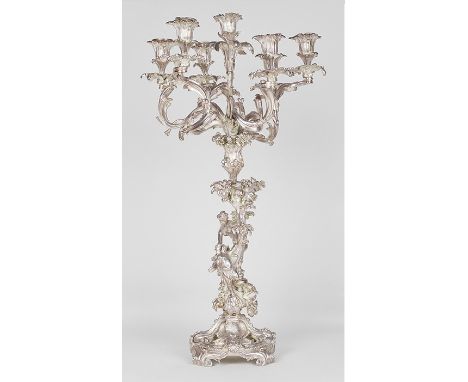 (Not silver as previously stated.) A pair of 19th century continental white metal Rococo style seven light candelabrum, stand