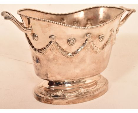 A fine heavy 925 silver wine cooler in classical style standing on oval foot with leaf decoration, main body festooned with w