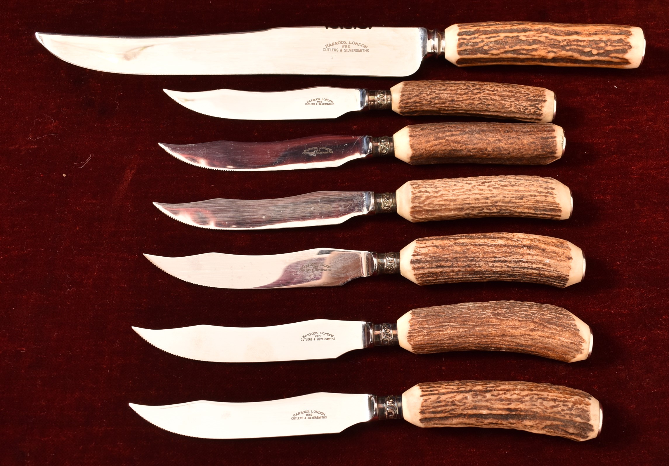 A Harrods of London set of six deer antler handled knives and one