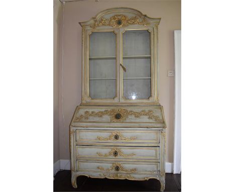 A 19th Century painted Bureau bookcase, standing on shaped feet, rising to three drawers with full front and with fitted inte