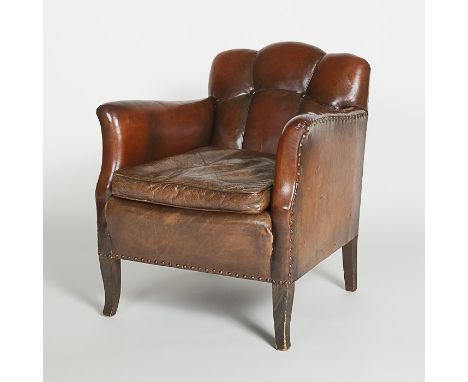 A vintage 1930's French style leather club or library chair, standing on four wooden legs. The straight sided arms with brass