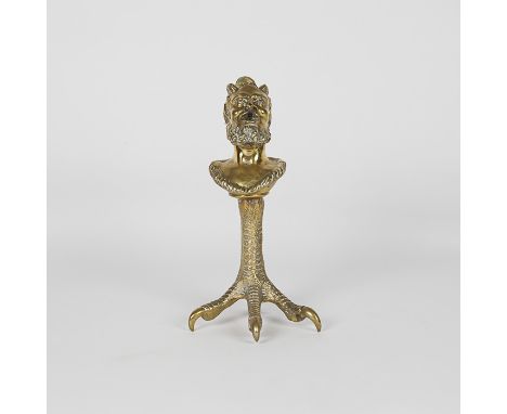 A 19th century cast brass table top cigar lighter formed with the head of Pan or the devil, standing on a four clawed foot, t