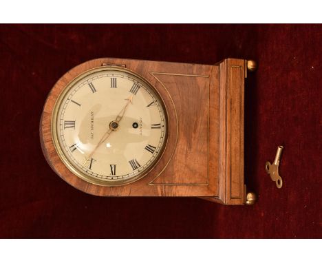 A Regency period mantle clock, standing on four brass ball feet of domed shape, the walnut case inlaid with brass, the enamel