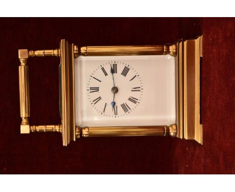 A late 19th, early 20th Century French brass cased carriage clock. The enamel dial with Roman numerals and an outer minute tr