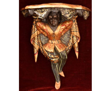 An ebonised and giltwood painted wall bracket in the form of a blackamoor figure. W=42cm