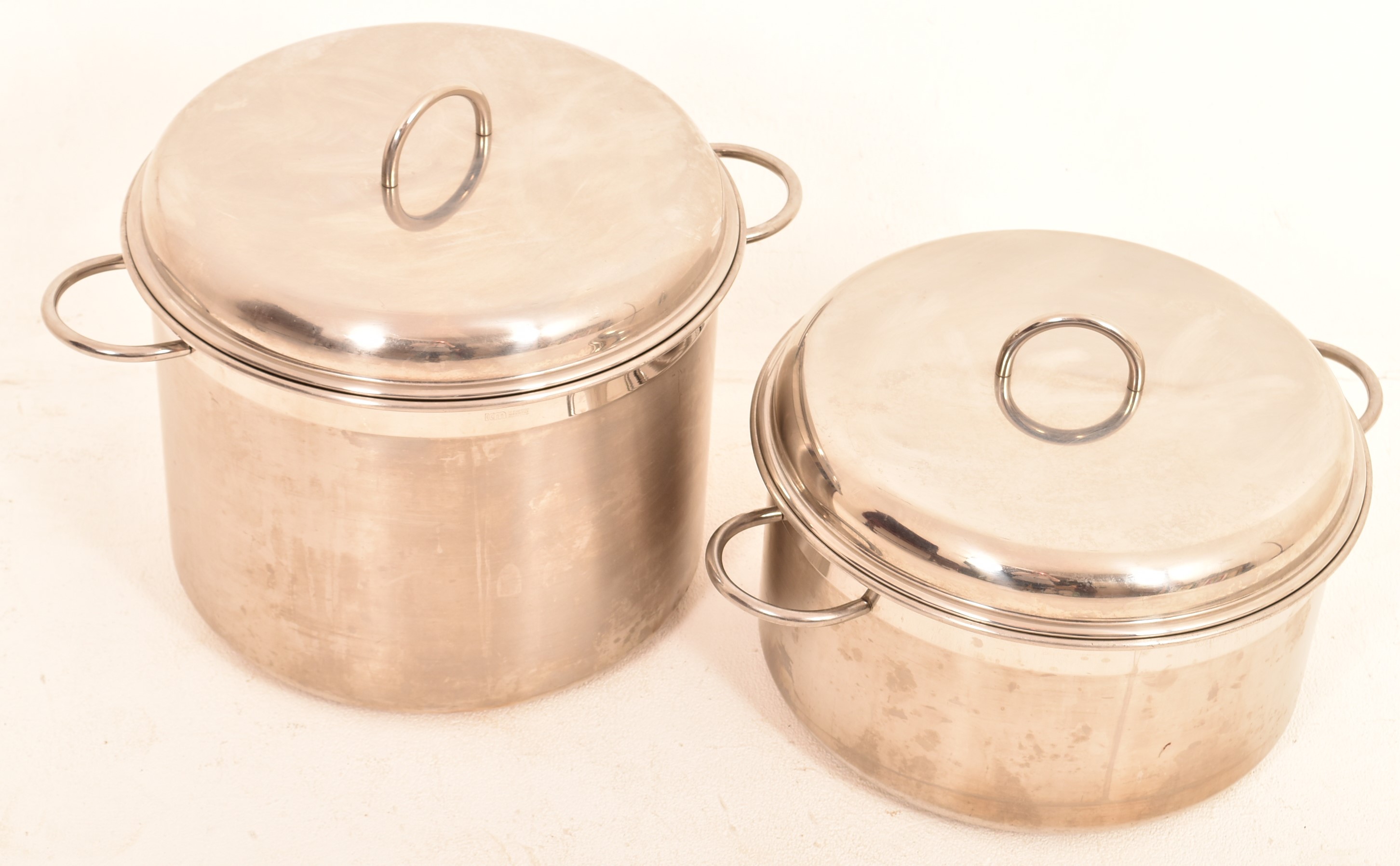 A large pair of stainless steel cooking pots. H=32, W=47cm
