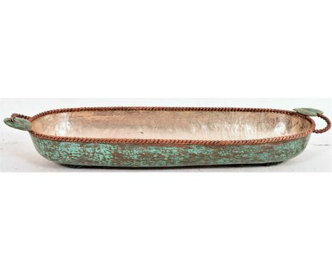 A good beaten copper trough with decorative ropework rims, green patinated main body, two ropework handles with leaf decorati