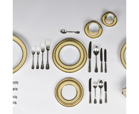 A magnificent and large Limoges dining service. The white under glazed body with yellow ground and decorative gilded banding.