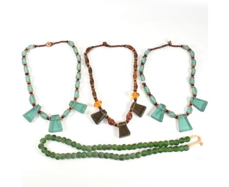 A collection of South East Asian glass bead necklaces. The lot to include two blue glass bead facet cut necklaces interspaced