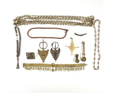 A collection of yellow tone metal jewellery and accessories. The lot to include an African yellow tone metal Agadez Tuareg cr