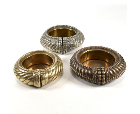 Three Omani metal bangles converted into trinket dishes. The metal bangles/anklets having a twisted design and metal bead wor