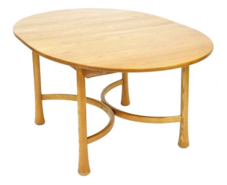 An Ercol elm draw leaf dining table, the oval top raised on turned outswept legs, united by an x framed stretcher, Saville ra