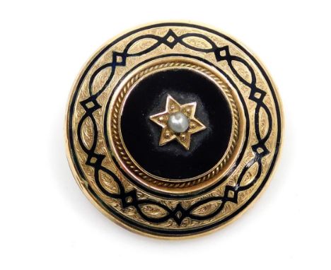 A Victorian circular black and enamel and seed pearl set mourning brooch,  in yellow metal, with foliate engraving, 9.8g all 