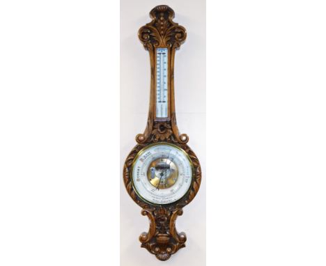 A Victorian oak cased Walker of Newmarket aneroid wall barometer, with a circular enamel dial and mercury Fahrenheit and cent