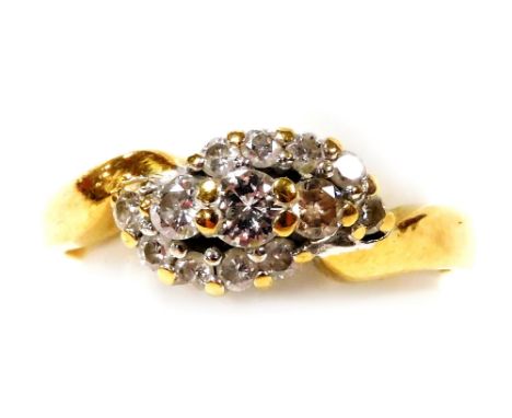 An 18ct gold and diamond ring, in a cross over style, size M, 3.4g. 