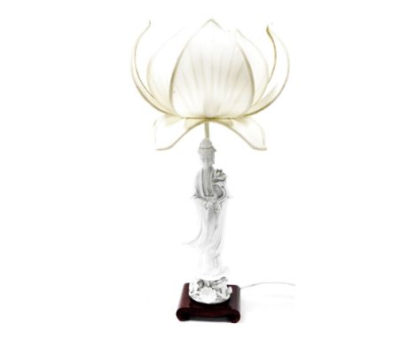 A modern blanc de chine figural table lamp, of Guanyin holding a lotus flower, mounted on a scrolling hardwood base, 40cm hig