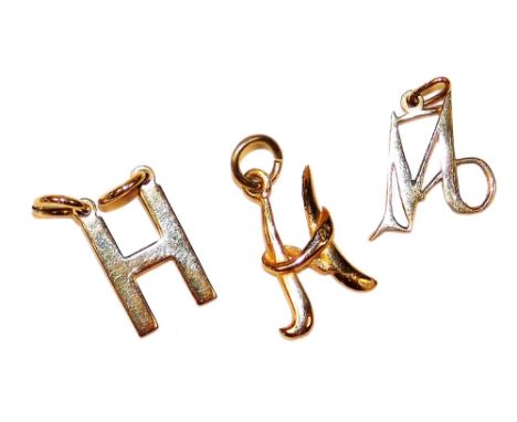 Three 9ct gold letter charms, comprising H, another, and M, 1.5g.