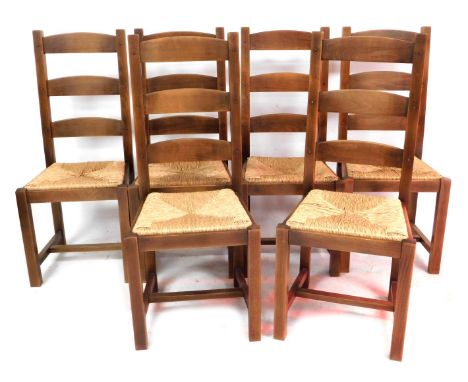 A set of six light oak ladder back dining chairs, with rush seats, raised on square legs united by an H frame stretcher.